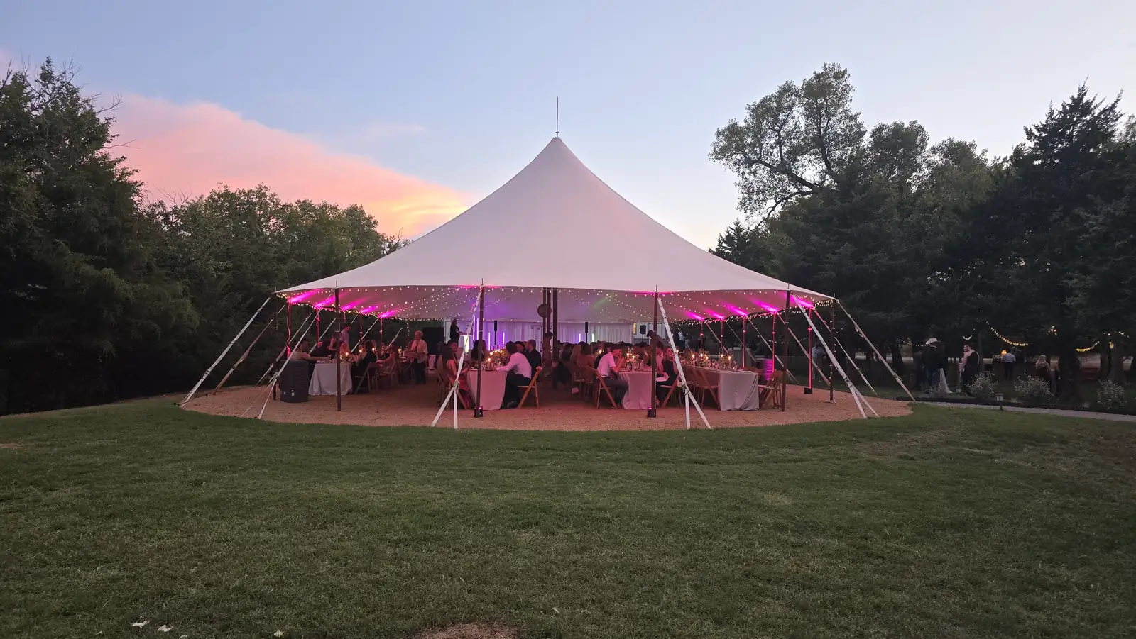 The pole tent glowing pink at dusk