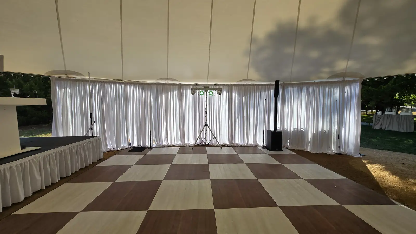 The tent interior with sheer white drape walls before doors