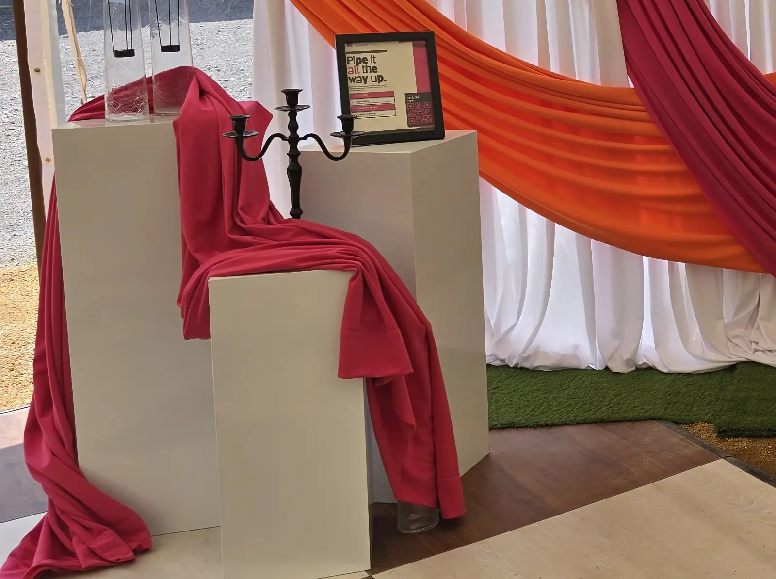 Our three white metal pillars, draped in hot pink at our open house booth