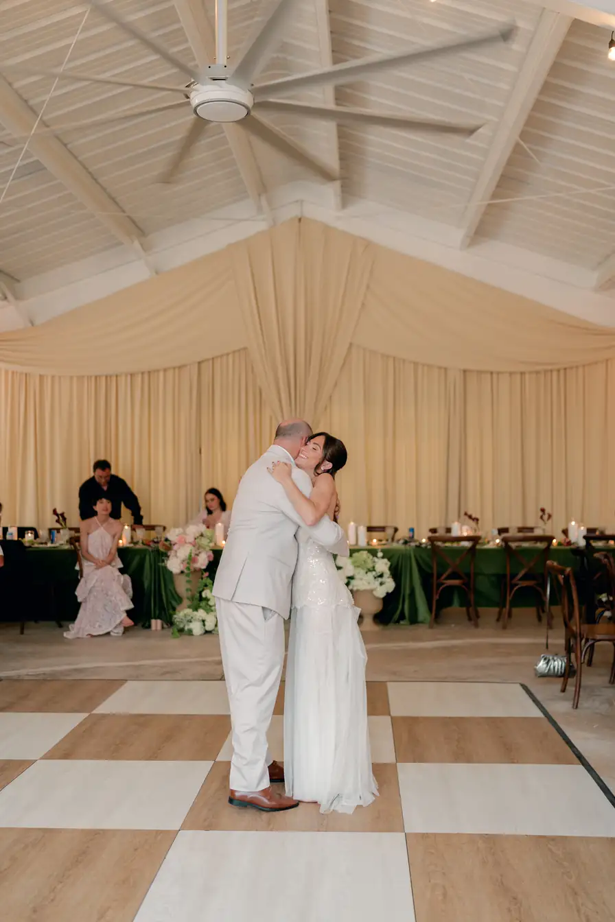 First dance on the checkered floor in front of the cream drapery